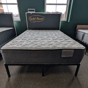 Mattress on a bed frame with 'Gold Bond' branding in a room setting.