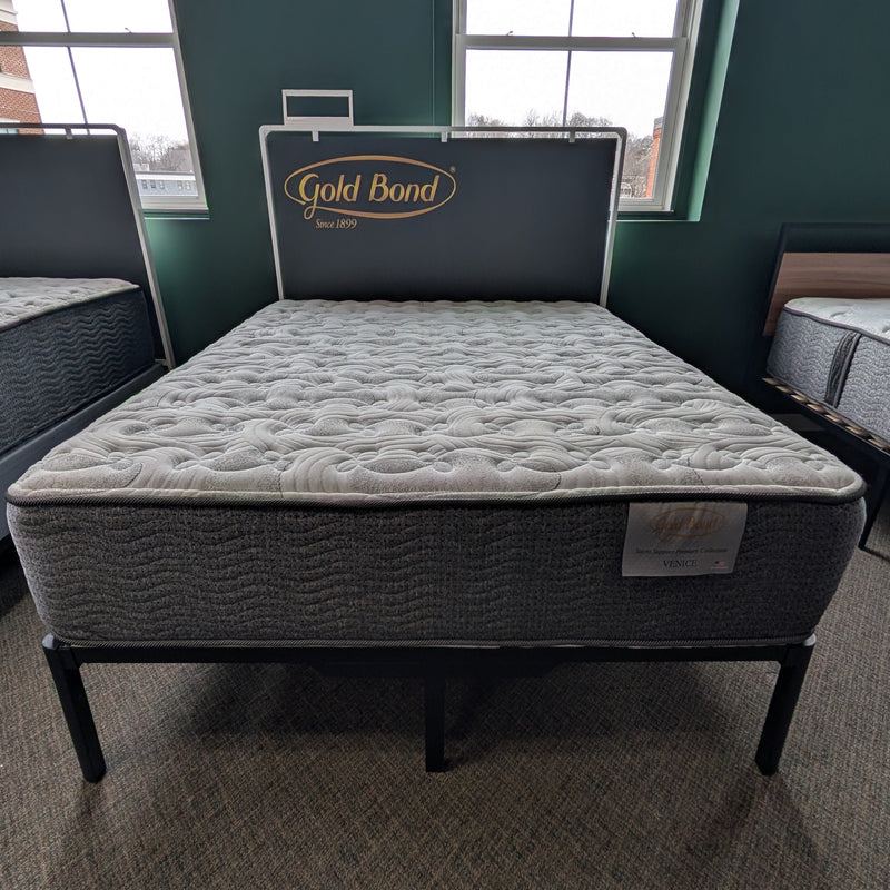 Mattress on a bed frame with 'Gold Bond' branding in a room setting.
